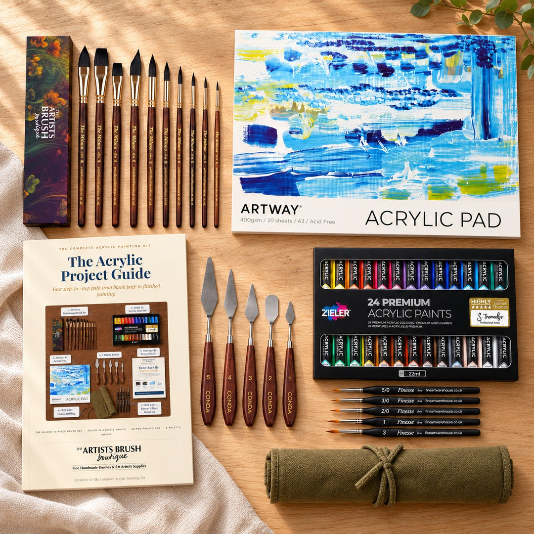 The Complete Acrylic Painting Kit on an oak table: Milano brushes and gift box, Artway A3 acrylic pad, Zieler 24 acrylic paints, palette knives, project guide, Finesse brushes and canvas roll bag